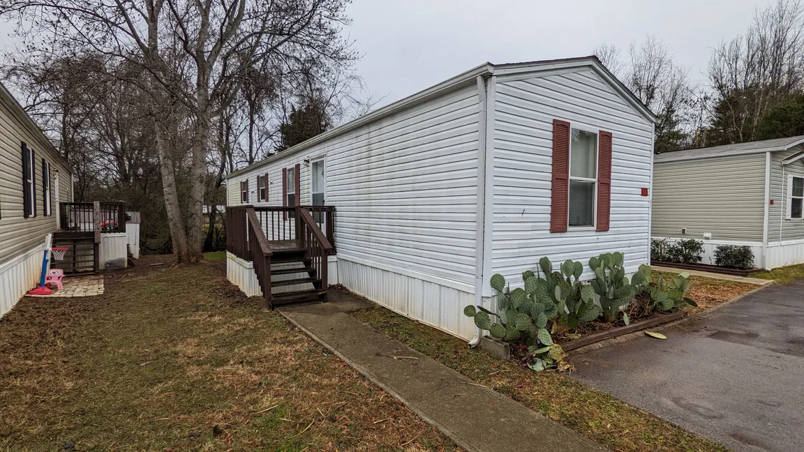 white singlewide mobile home located in Grand Oaks Mobile Home Park Powell, TN knox county