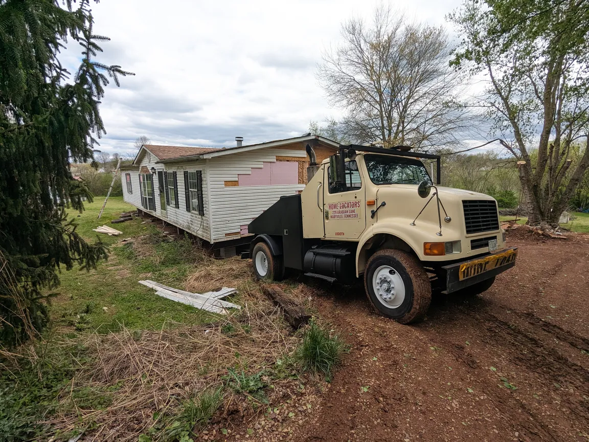 mobile home toter hooked to doublewide mobile home