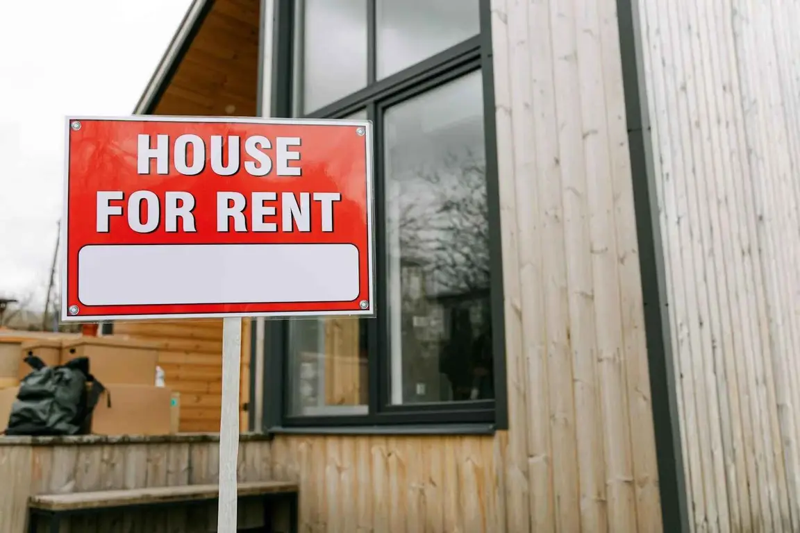 House for rent sign in front of a home