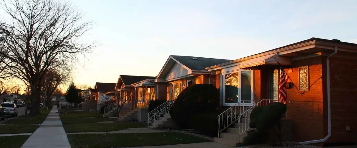 row of brick homes in a typical working class neighborhood at sunset