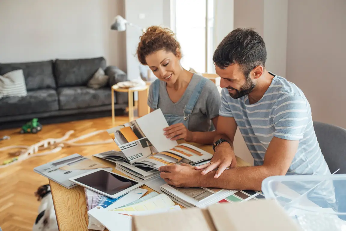 This image shows a man and a woman looking at options for home renovation projects.