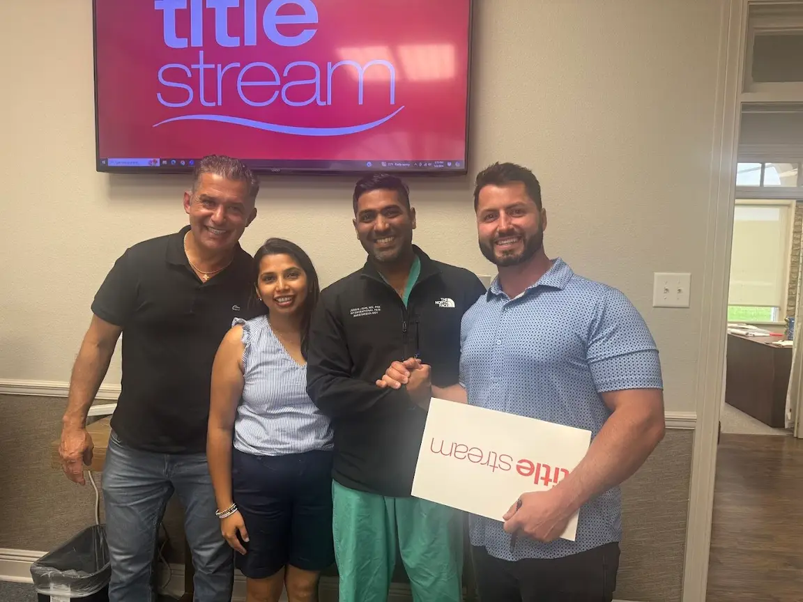 Sellers with the Bertucci Investment Group team at the title company after closing