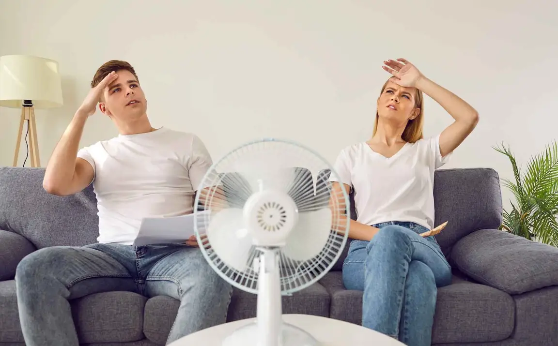 hot couple on couch with fan
