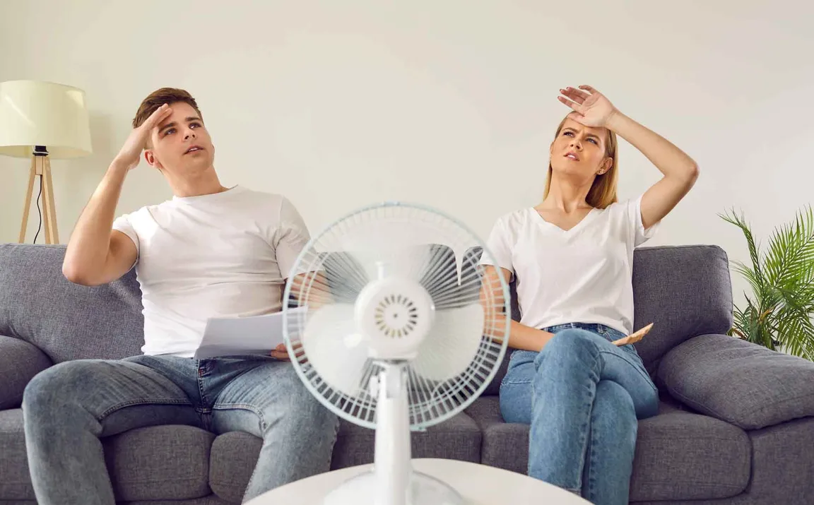 hot couple on couch with fan