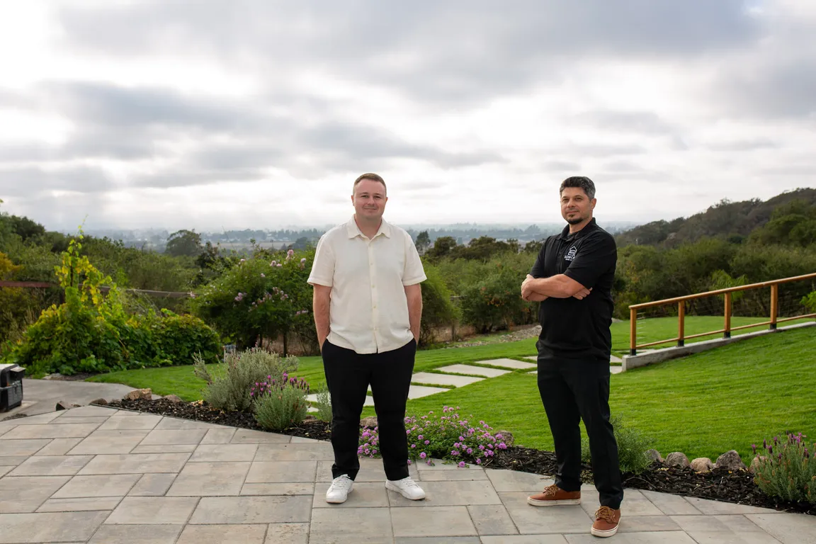 Wyatt and Brian from Sonoma Home Buyers standing on a patio with Sonoma County hills in the background.