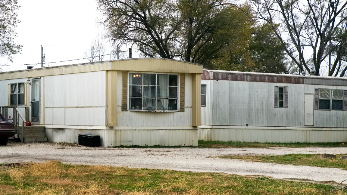 Two old mobile homes in a park that need to be moved