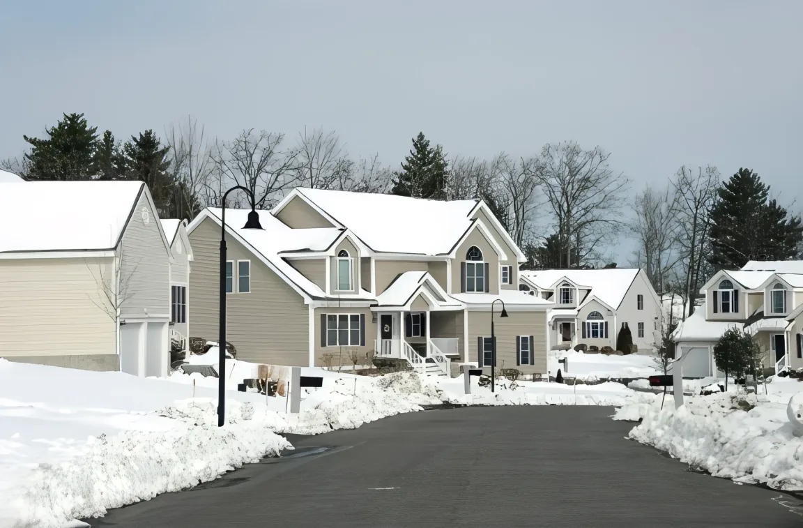 Snow-covered residential street in Middleboro, MA with modern homes.