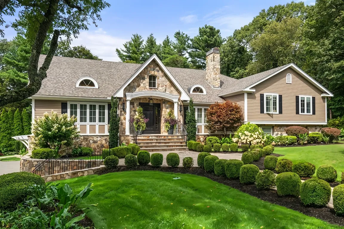 Charming single-story house with stone accents and landscaped garden.