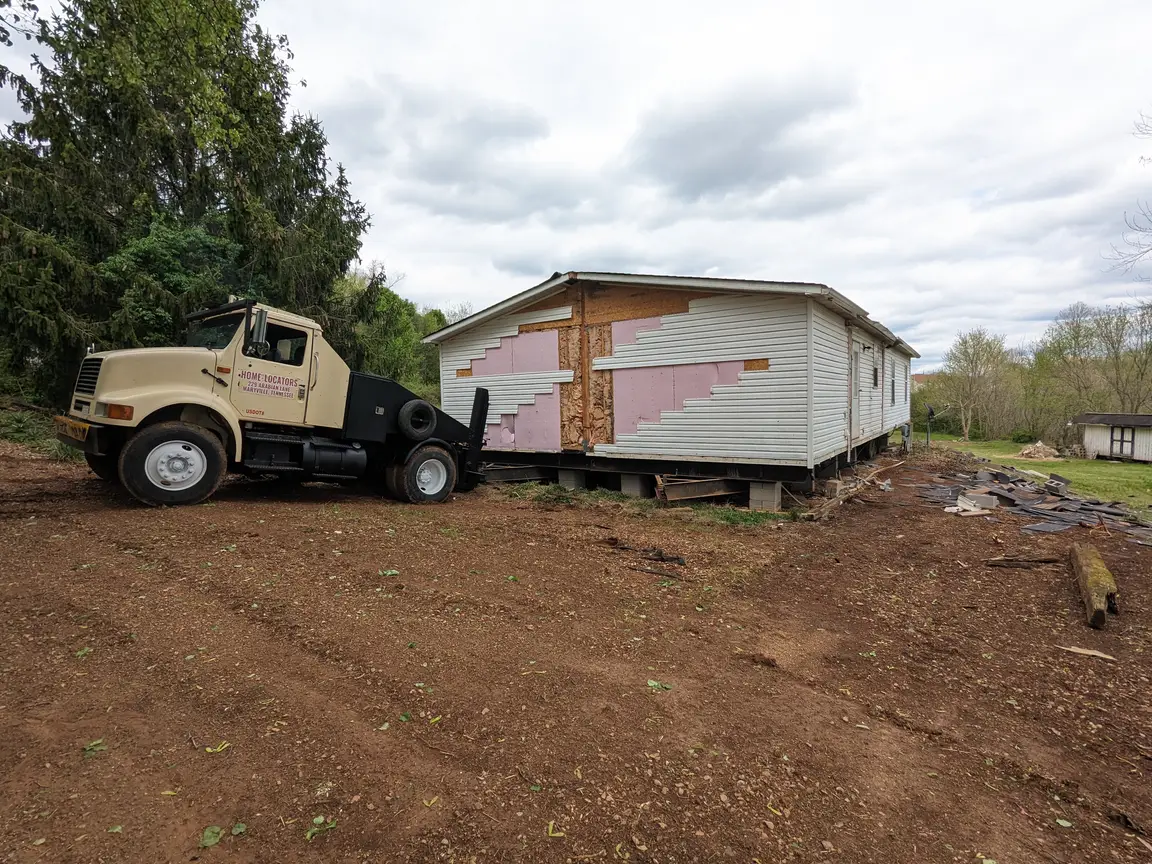 mobile home moving truck hooked up to double wide manufactured home