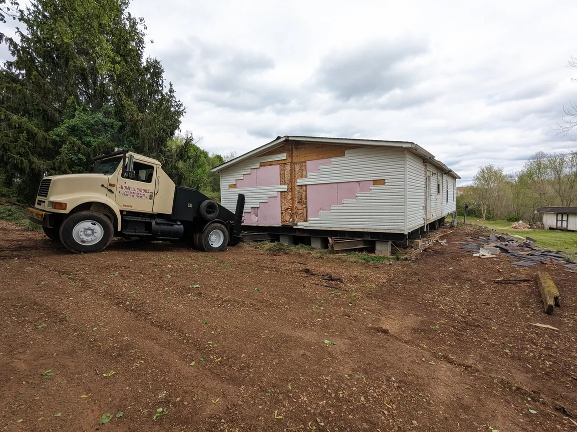 mobile home moving truck hooked up to double wide manufactured home