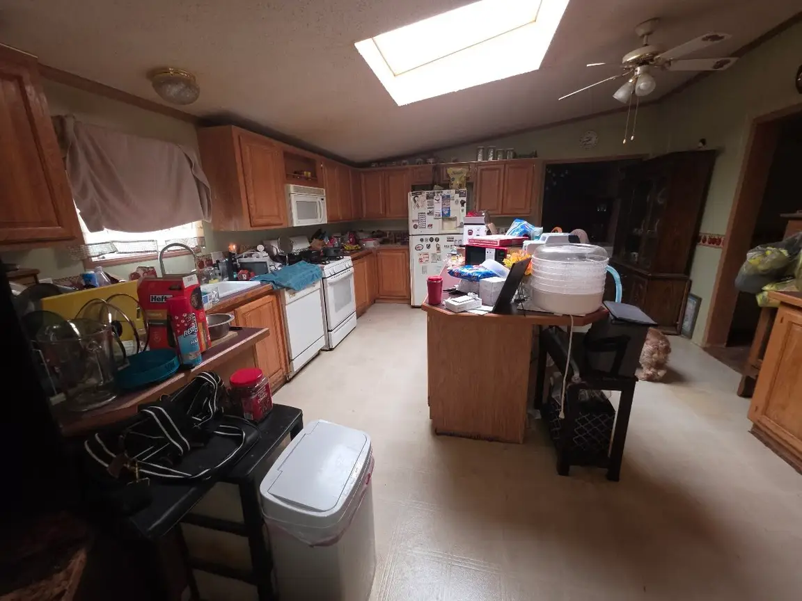 Cluttered kitchen in a house sold as-is for cash, the way owners sell their house as-is in Dayton
