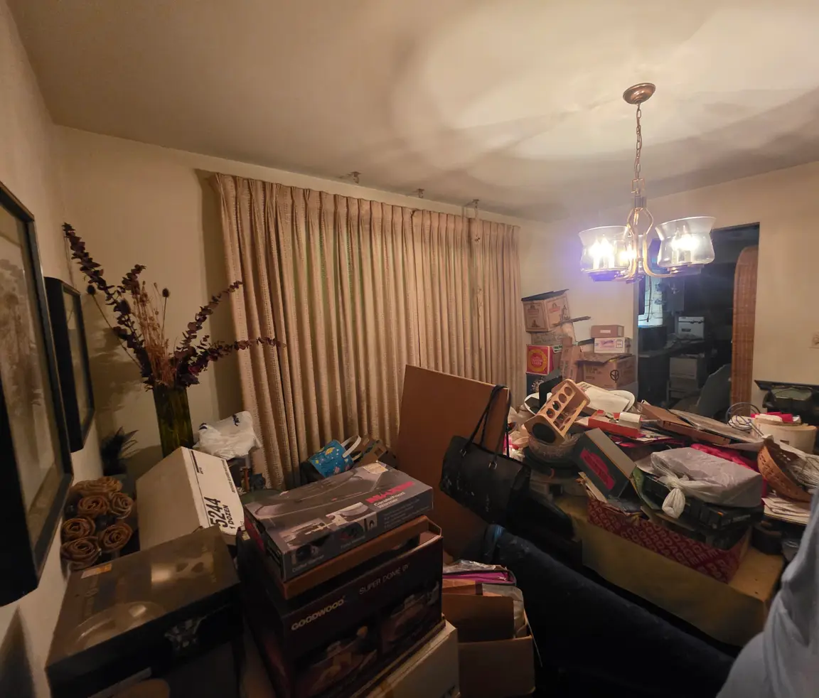 Living room full of belongings in an inherited house in Springfield, Ohio, sold as-is for cash