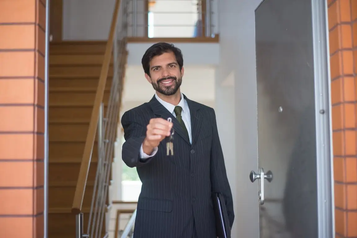 a man giving a key to a buyer