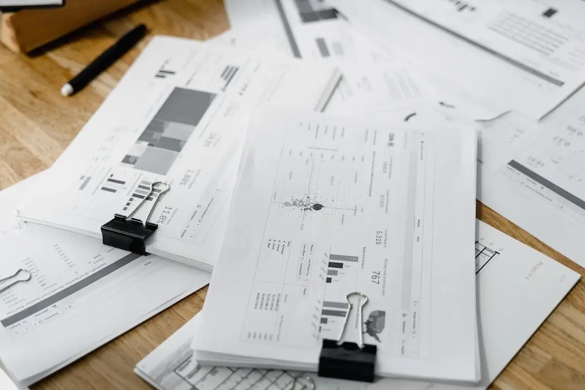 A massive pile of papers with graphs and notes on them