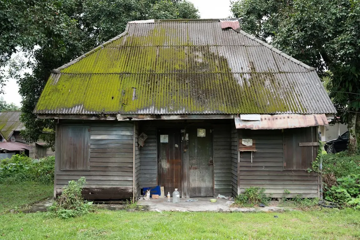 A very ugly house with moss on the roof