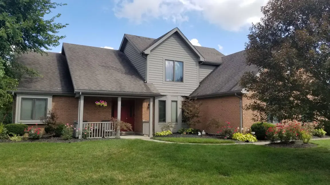 A home with a lot of grass in front of it located in Dayton.