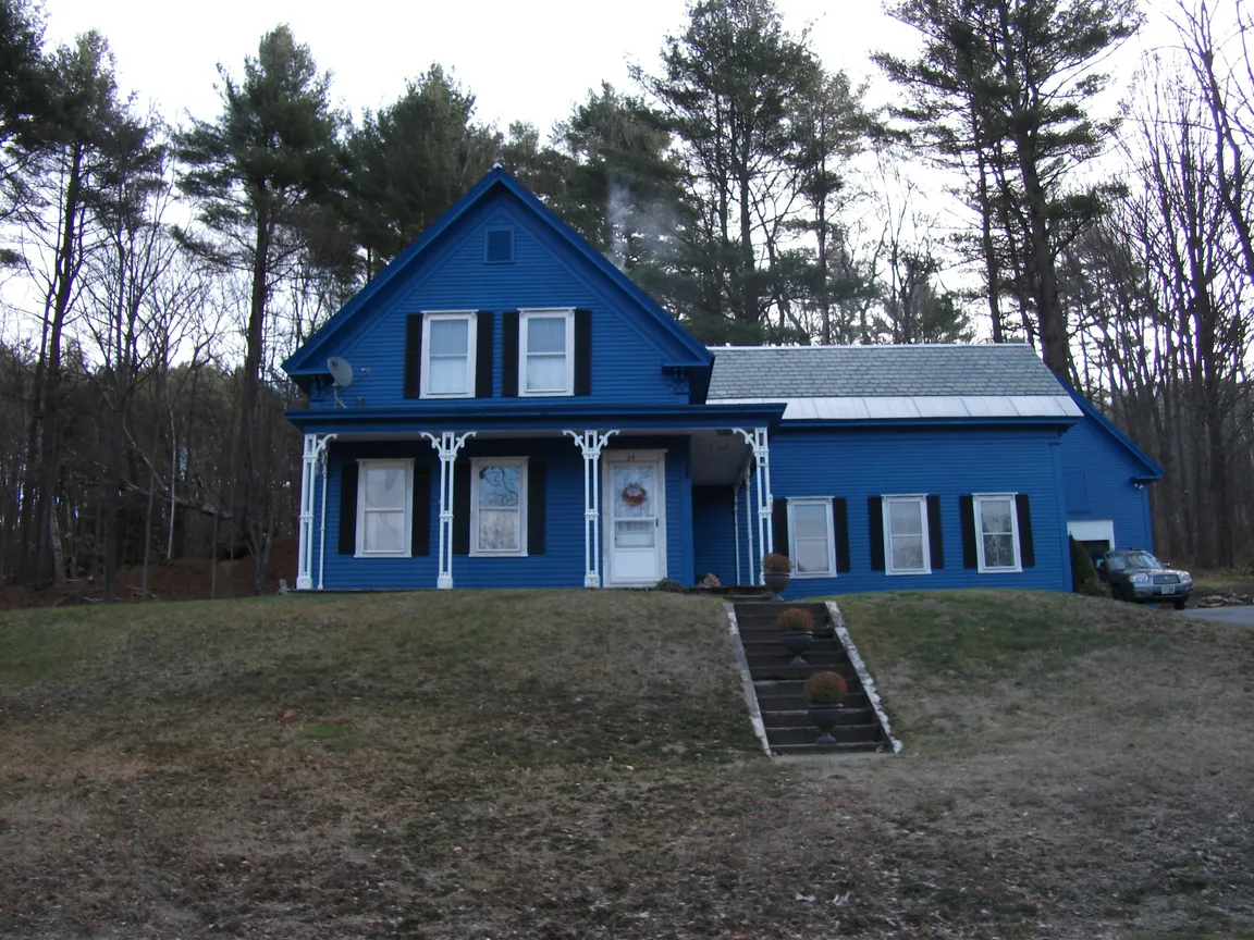 Blue rental house in Spofford, New Hampshire, representing a property a tired landlord is ready to sell