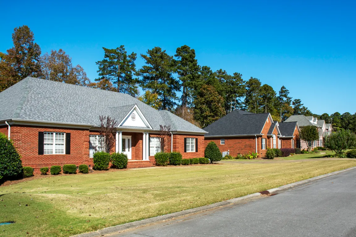 Spacious brick homes lined up in a quiet, residential neighborhood in Rome, GA.