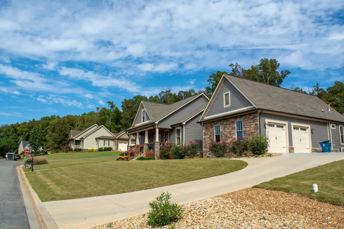 Gray home with elegant stone detailing, located in a residential neighborhood in Rome, Georgia.
