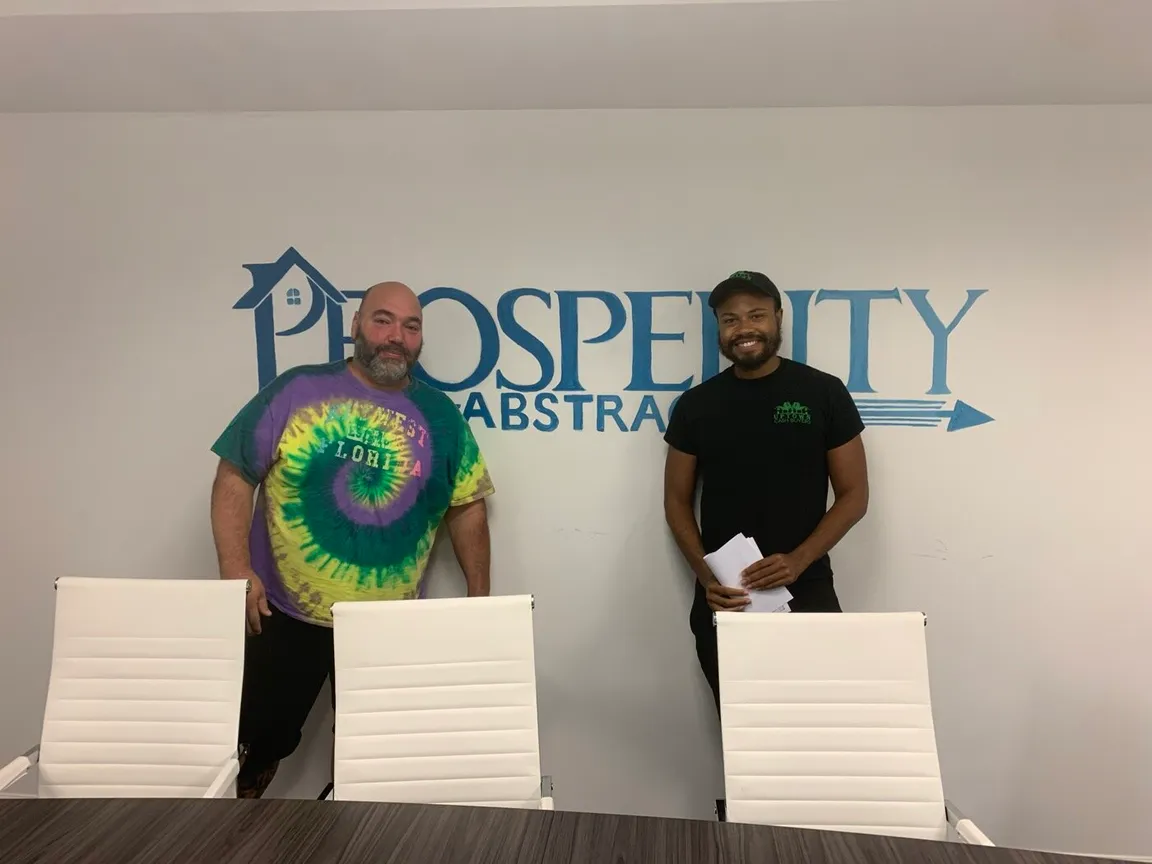 David from Liberty Pathway Homes with a seller at a cash home-sale closing in Philadelphia