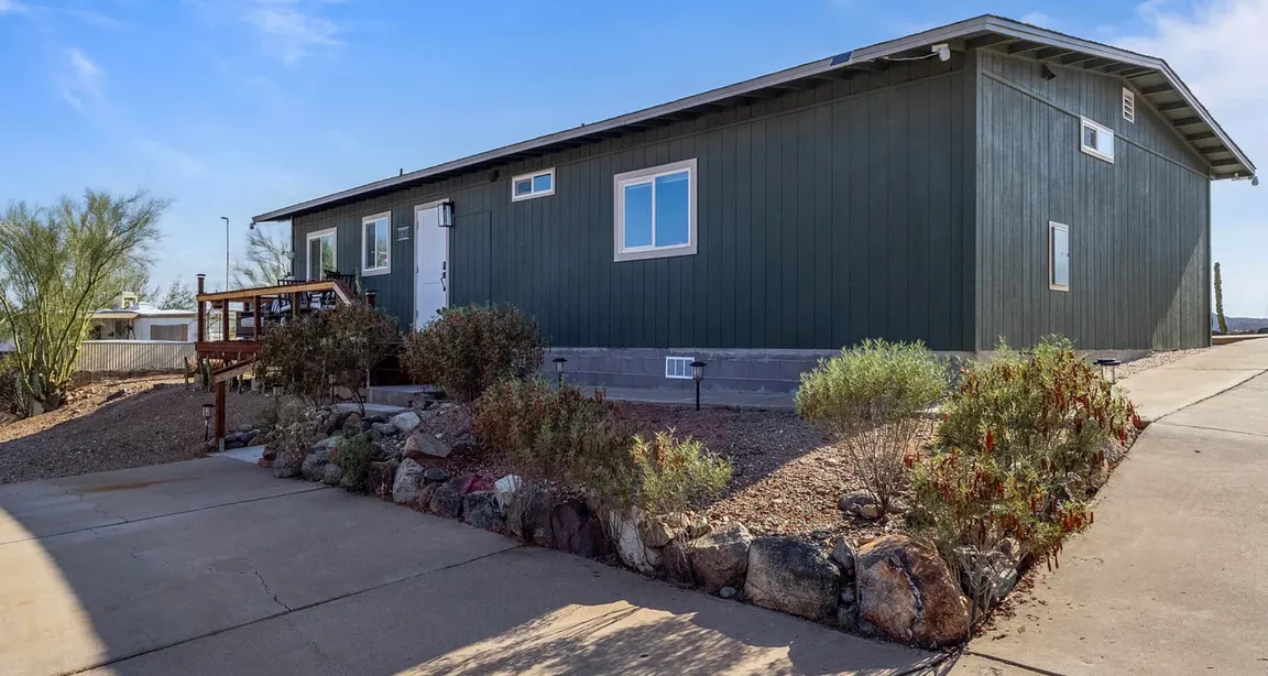 Manufactured home on large lot in Tucson with driveway and desert landscaping
