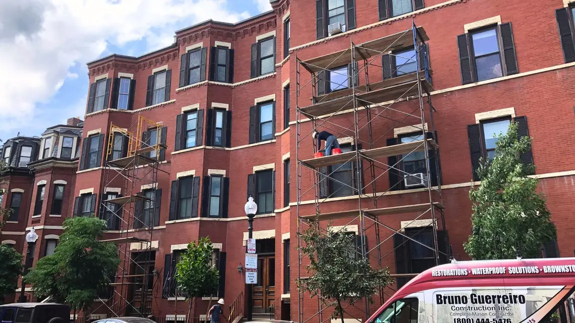 Exterior of a multi-story, brick apartment building.
