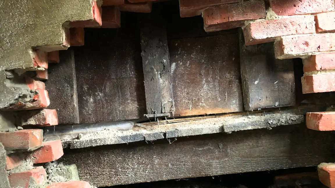 Exposed foundation in side of house.