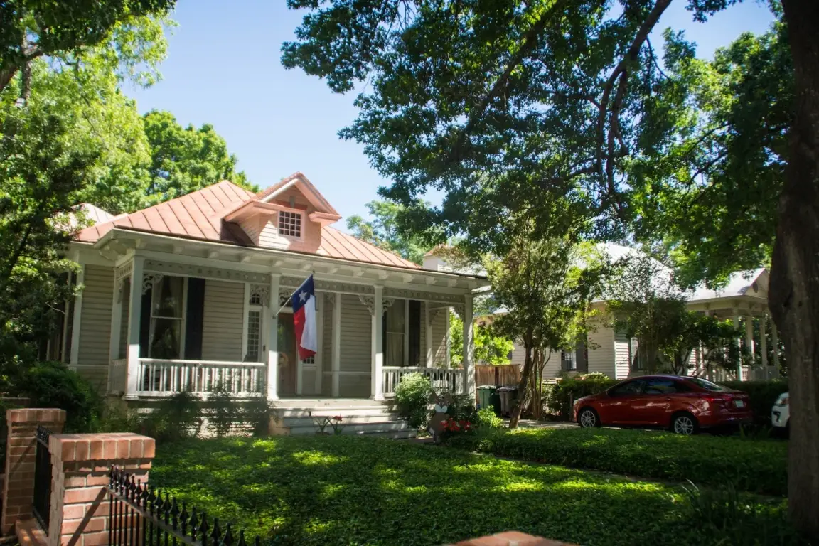 Front of a house in San Antonio, Texas with the Texas flag mounted off the front of the house
