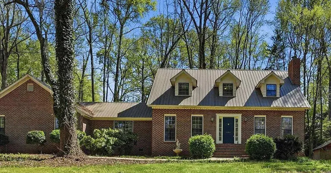 a newly designed cape cod home mixed with Southern Style cladding custom home by Redstone Ridge Homes in Huntsville, Alabama