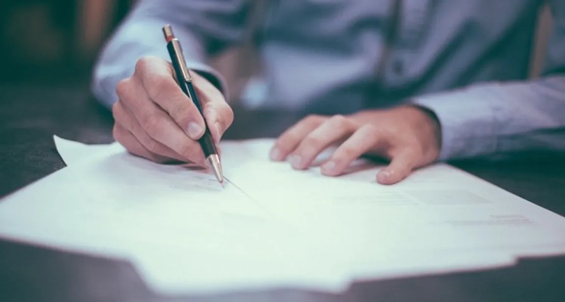 Man writing a contract