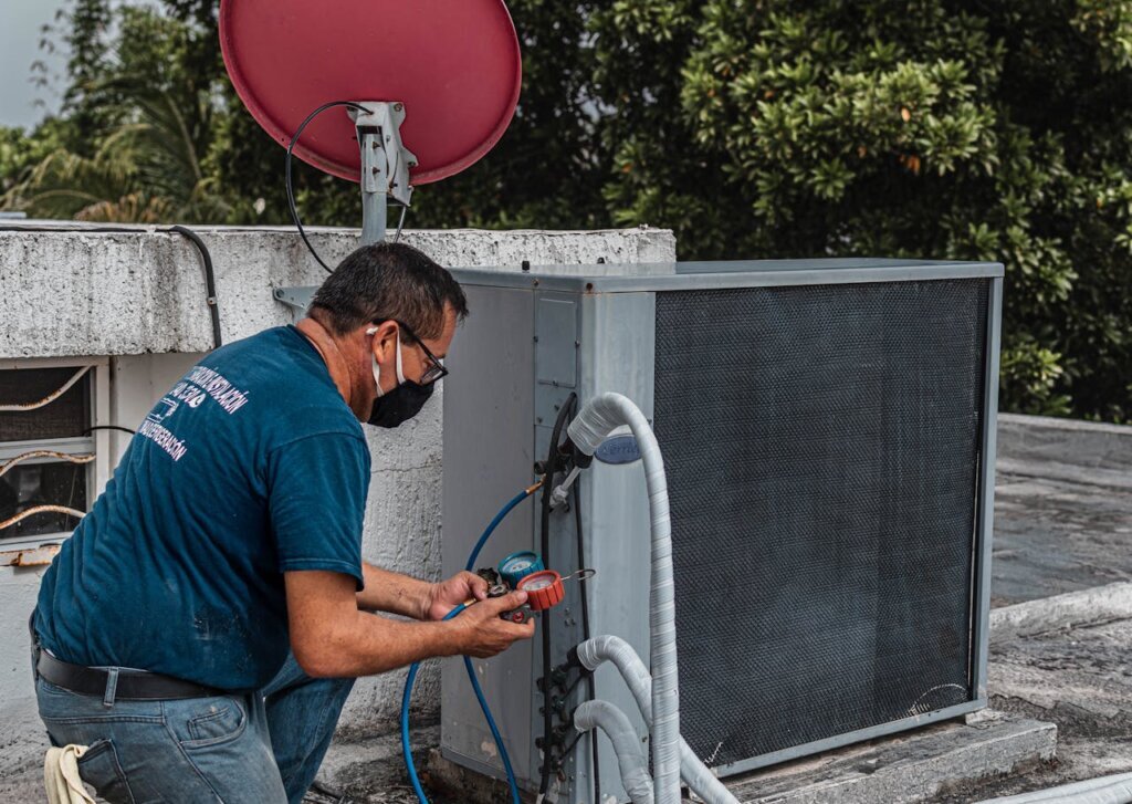 Technician servicing an HVAC Unit in Salem