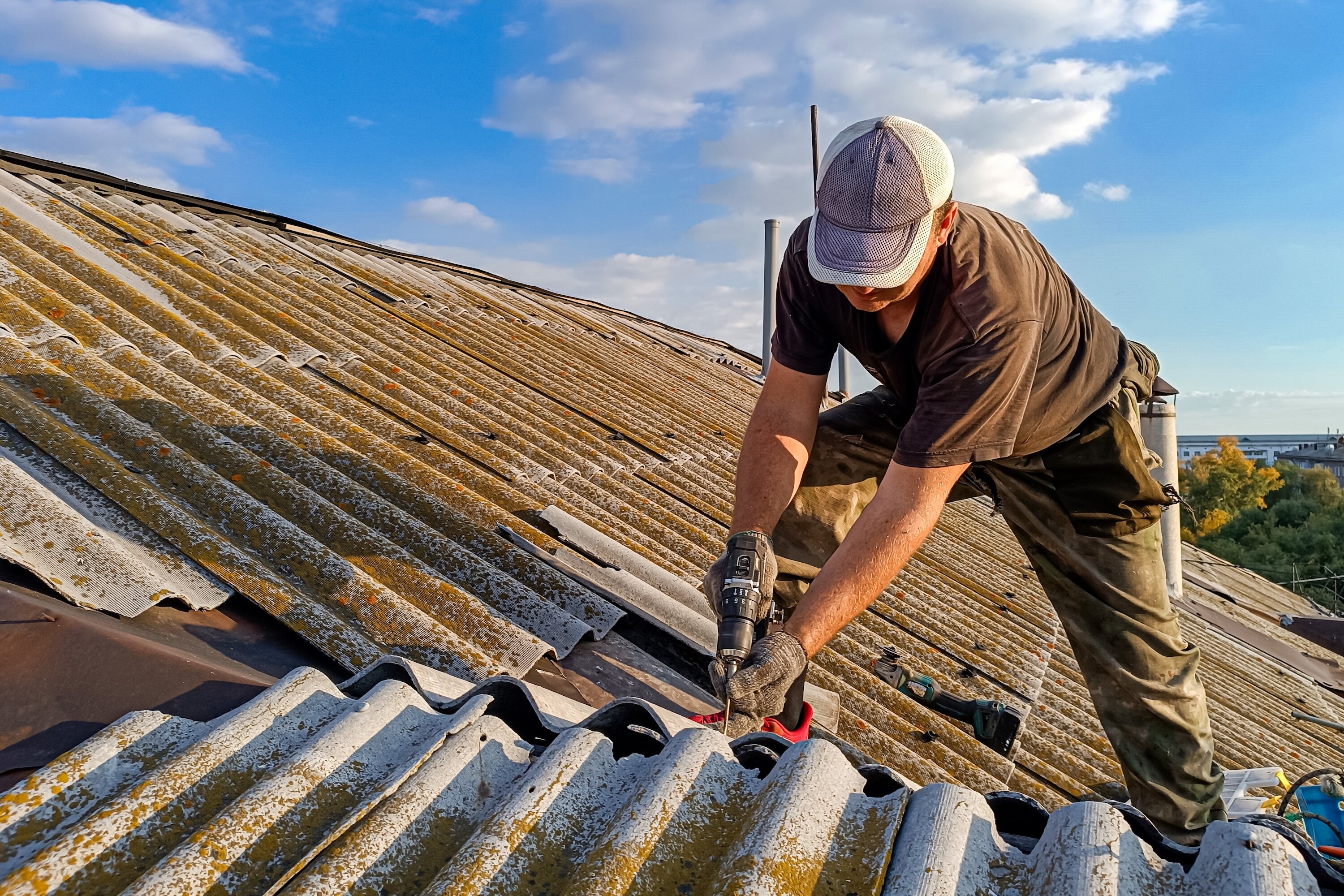 Roofer repairing a damaged roof