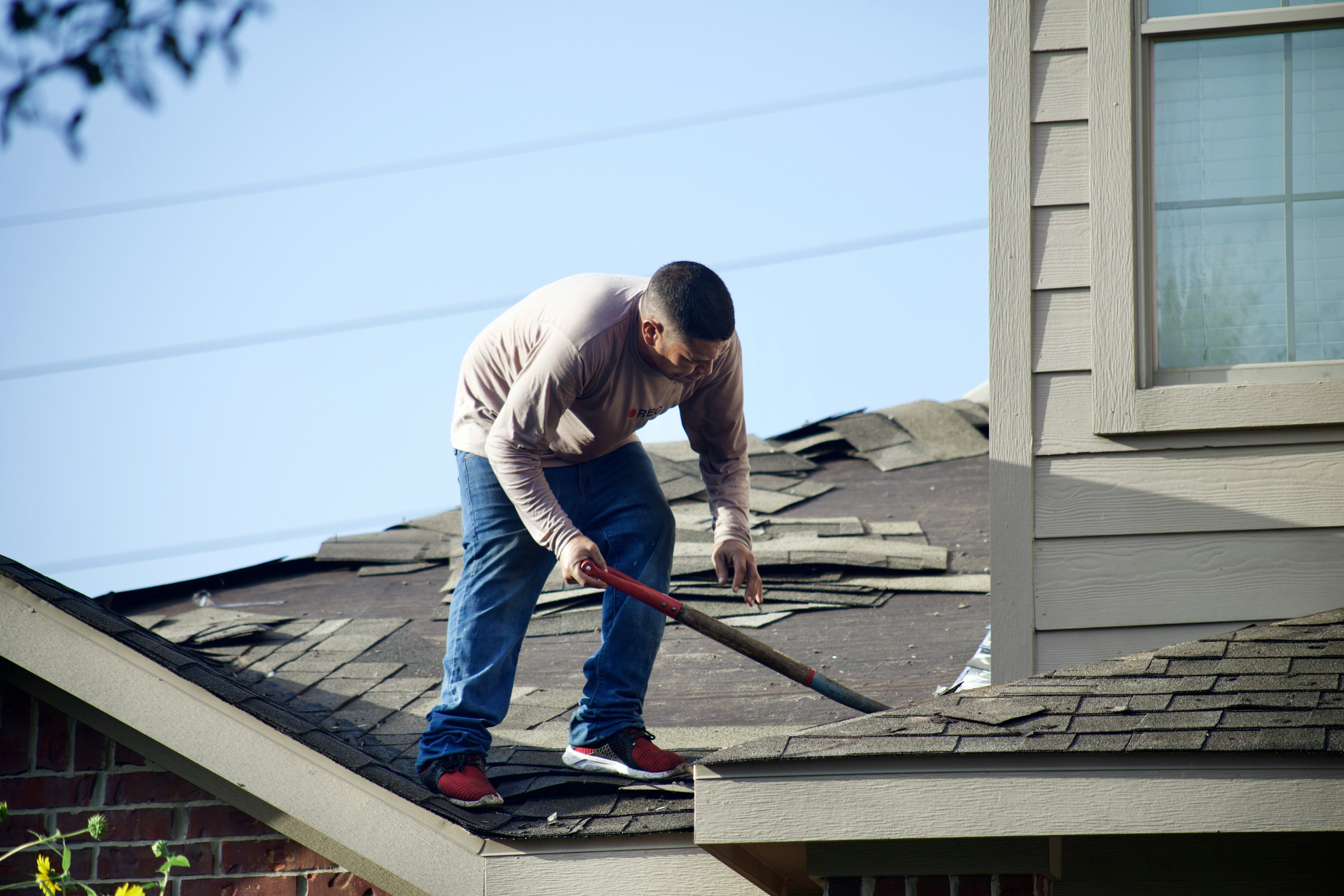 roofer repairing a home's roof
