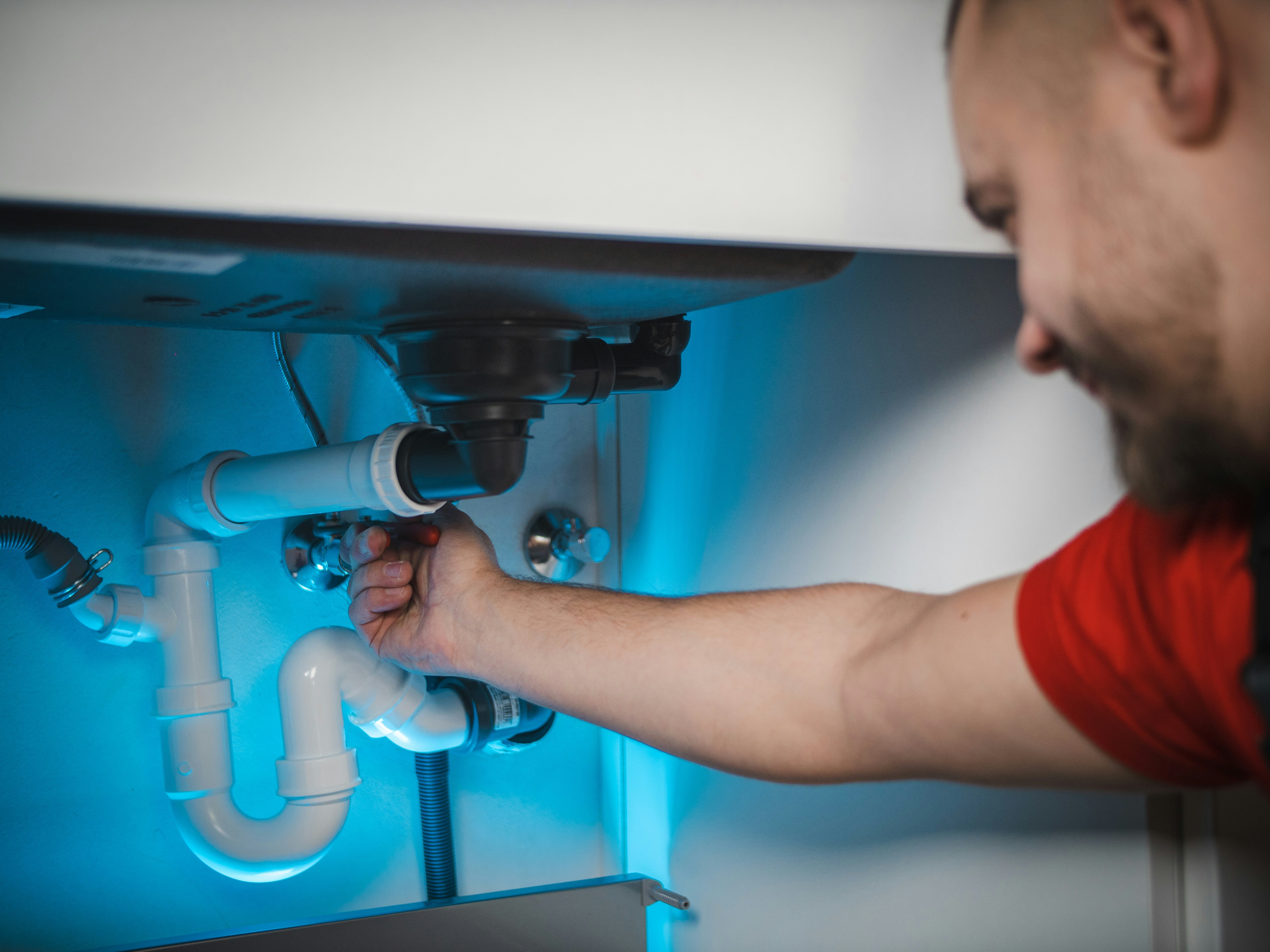 plumber servicing a drain