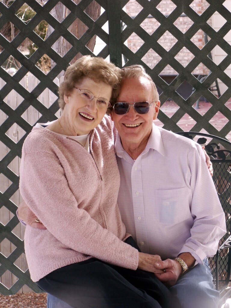 smiling man and woman with arms folded