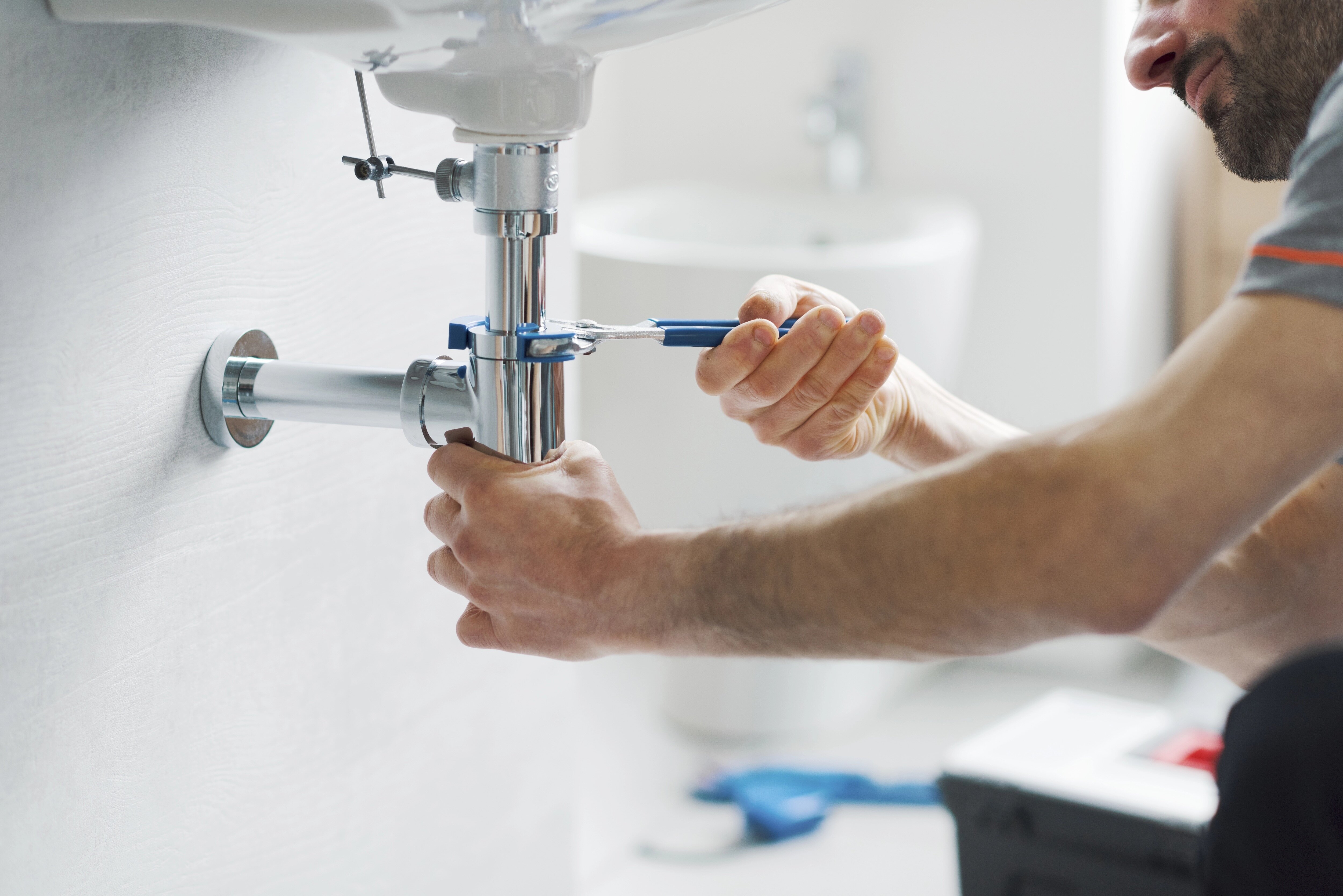 Plumber servicing a drain