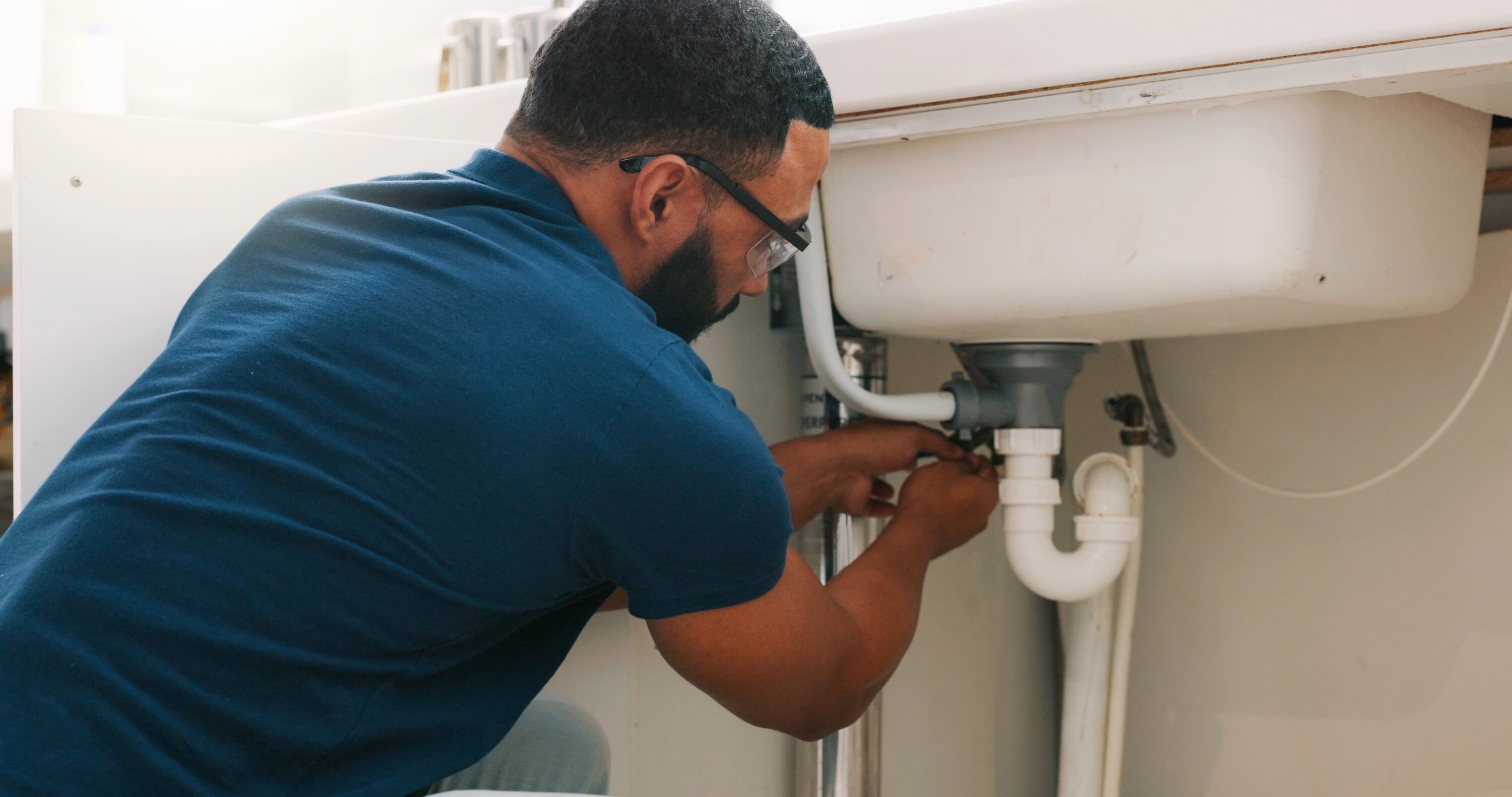 plumber servicing a drain