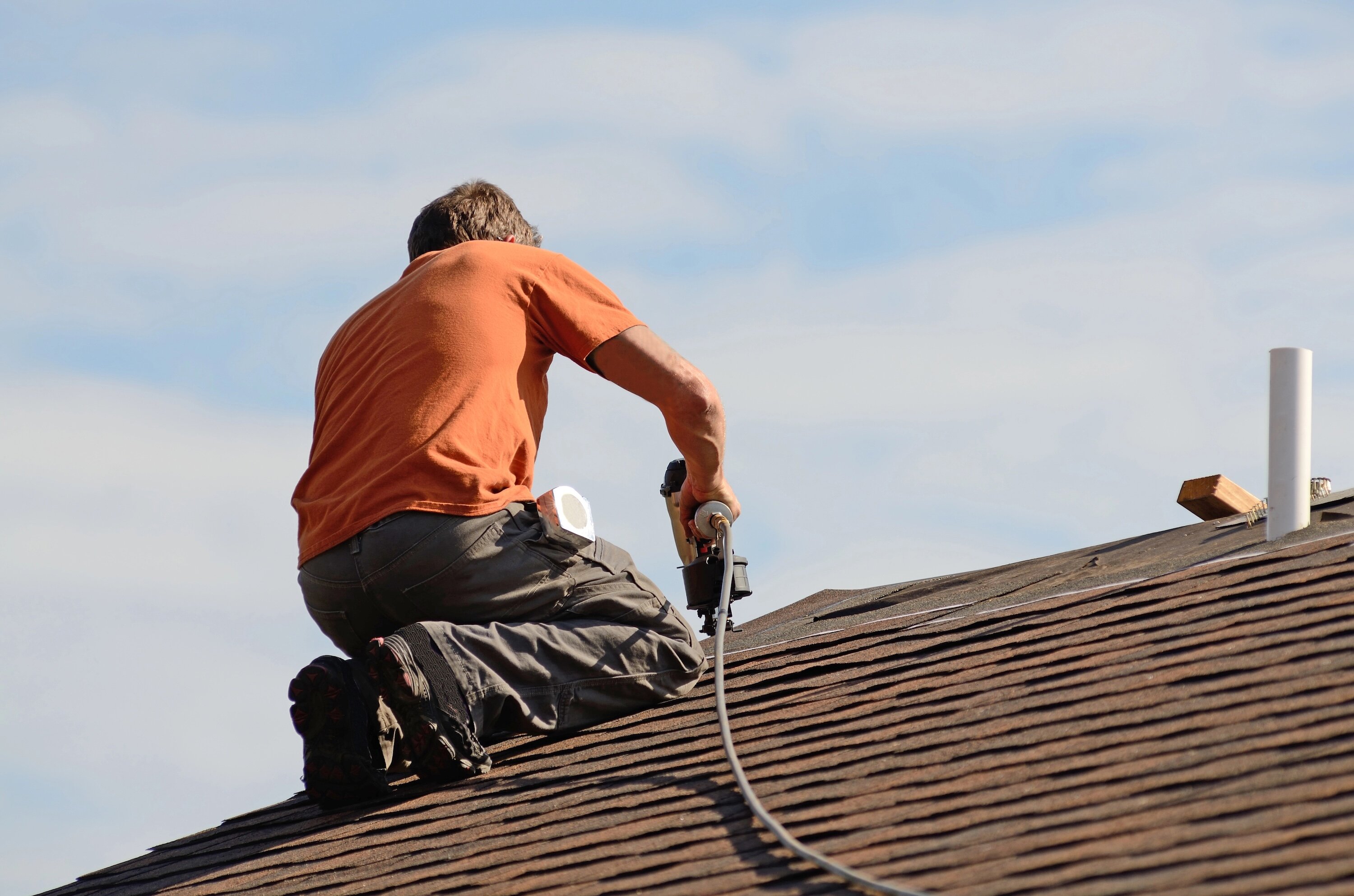 roofer installing shingles