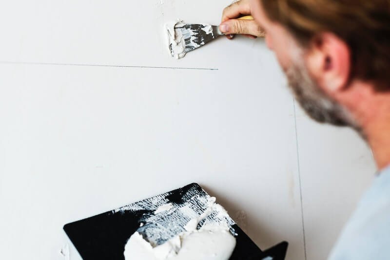Man making home repairs to help sell his home