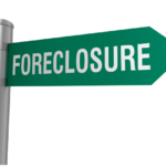 Green foreclosure road sign.