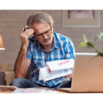 man looking over past due notices on his mortgage
