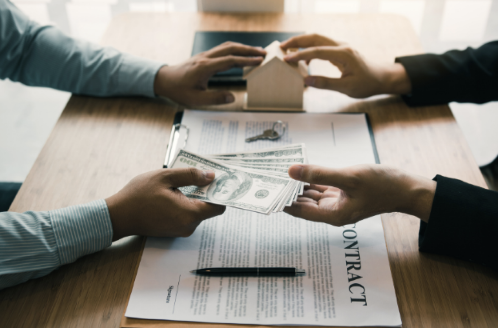 home buyer handing cash to the home seller at closing