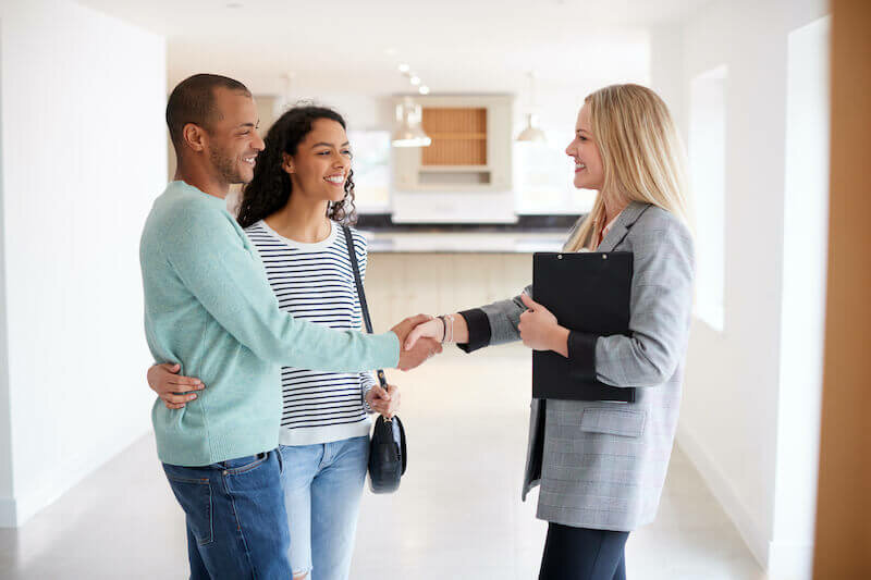 couple happily working with cash home buyer