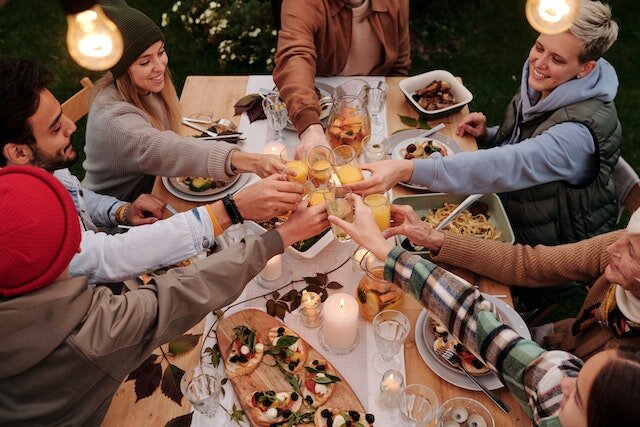 Group of people having a farewell dinner before a move