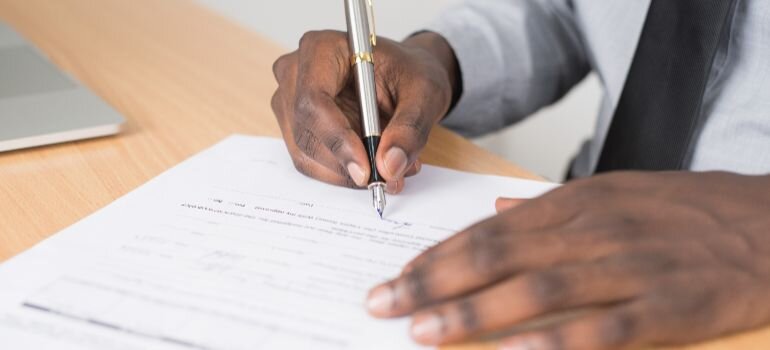 person handling mortgage paperwork