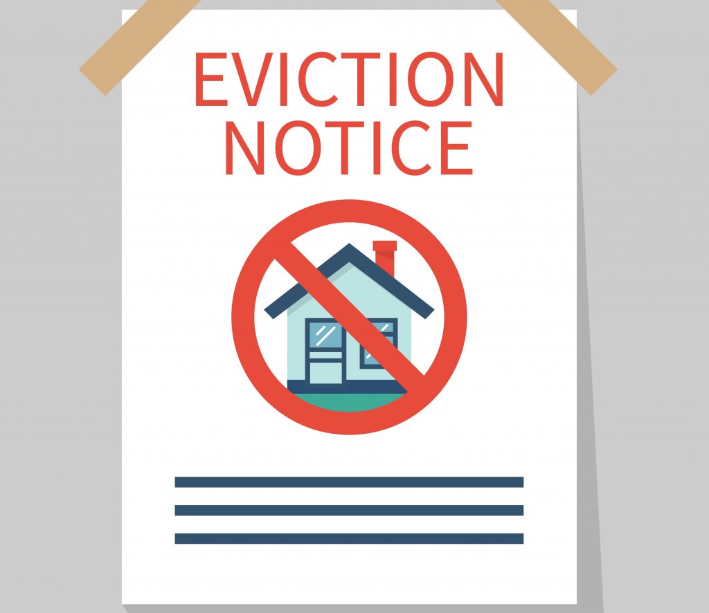 A paper taped to a door that says eviction notice.