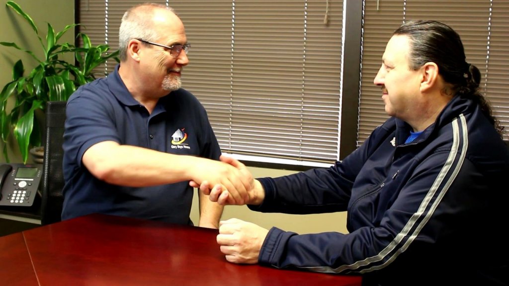 Company owner Gary Parker shaking hands with a client who sold their house to Gary Buys Houses