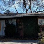 Small brick rambler house that needs repairs.