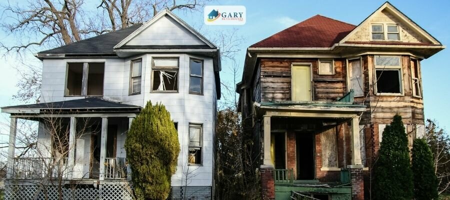 Two abandoned houses each two story with broken windows
