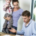 man woman & child at desk what to do behind in the house payment